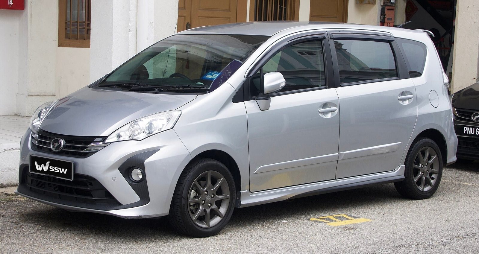 2019 Perodua Alza AV in silver, front three-quarter view parked outside a shop in Penang, Malaysia, in daylight
